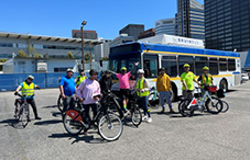 Bike class posing in front of BruinBus