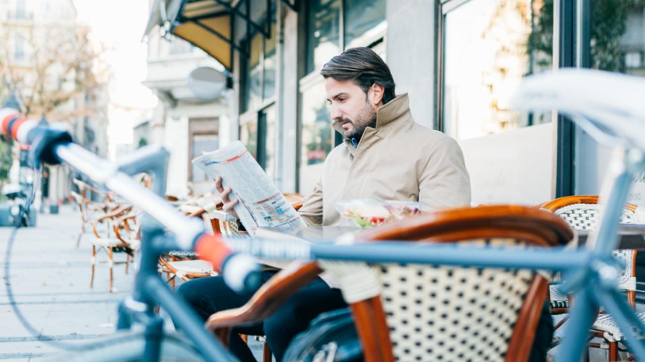 Guy on a bench reading the newspaper