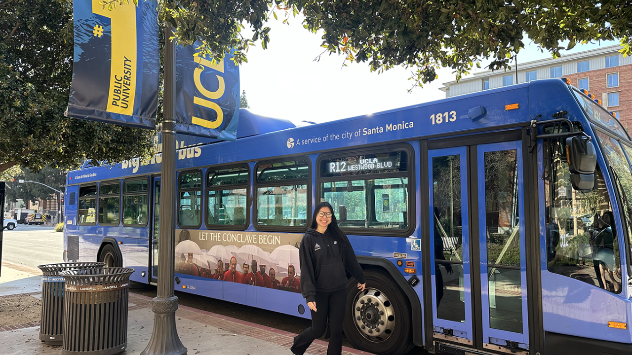UCLA Rec employee in front of Big Blue Bus on campus