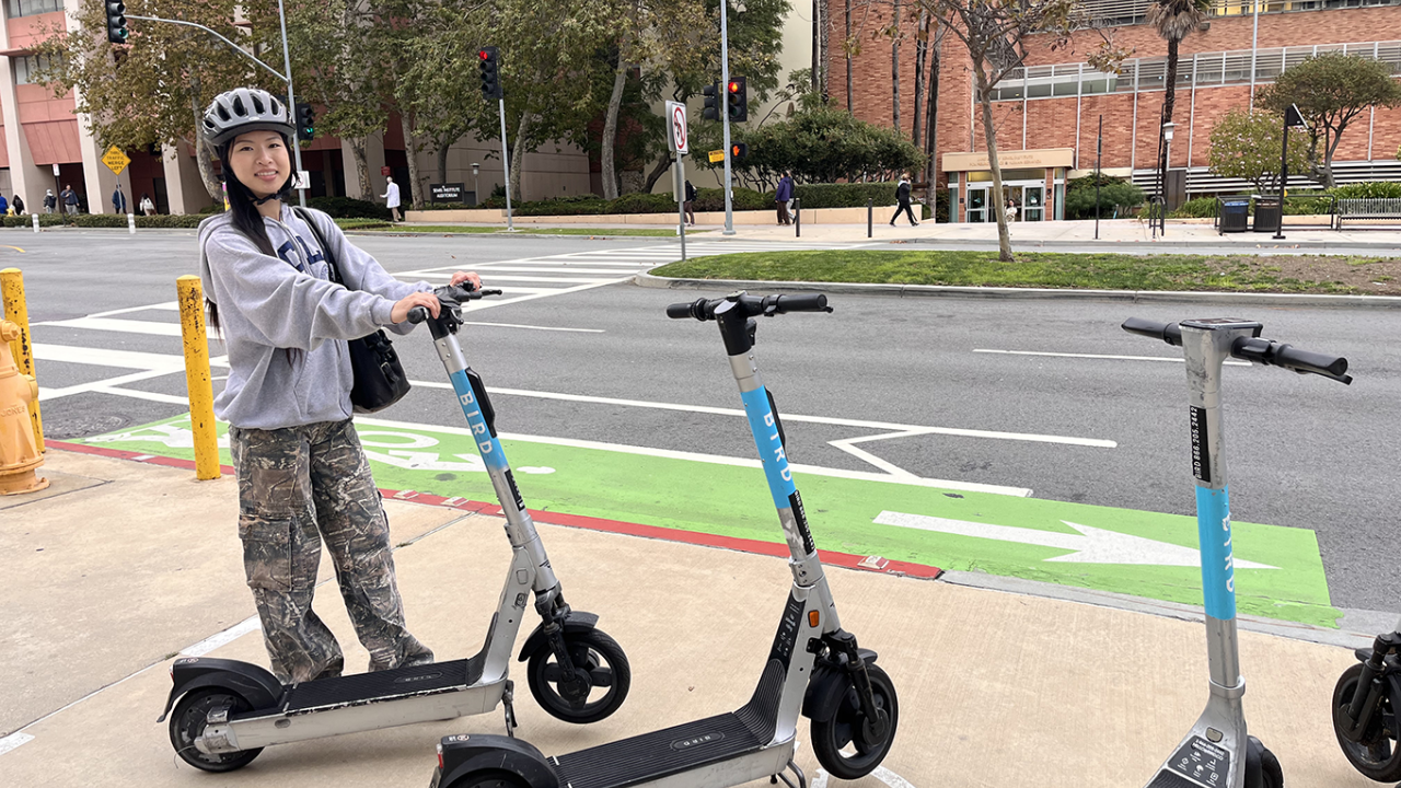 Student Liana parking her scooter in the designated area on campus.