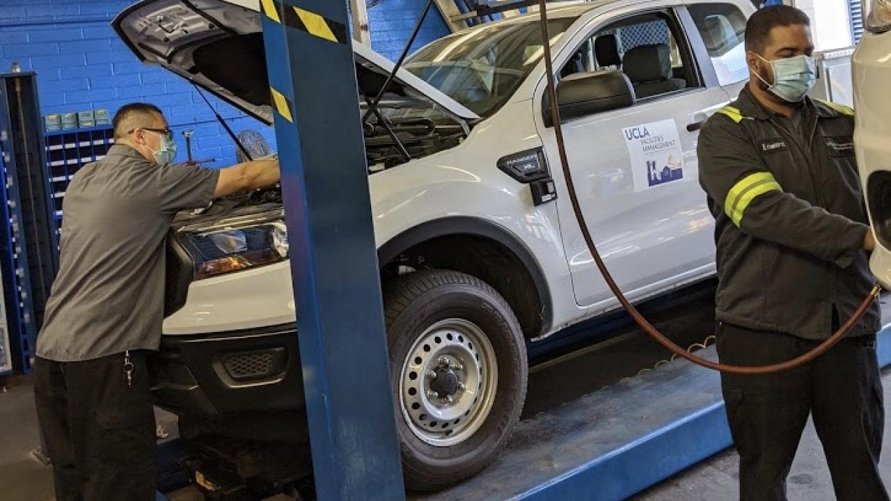 Technicians working on University vehicles