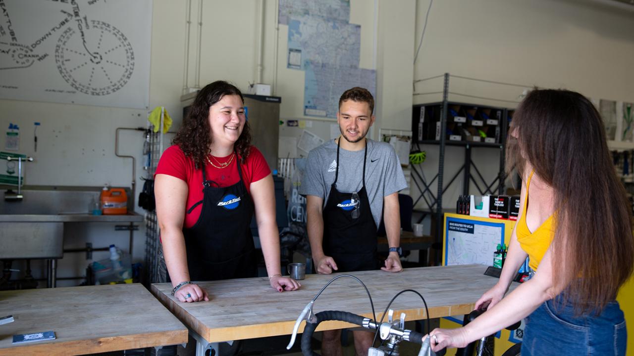 Nice UCLA Bike Shop staff assisting a Bruin bike rider.