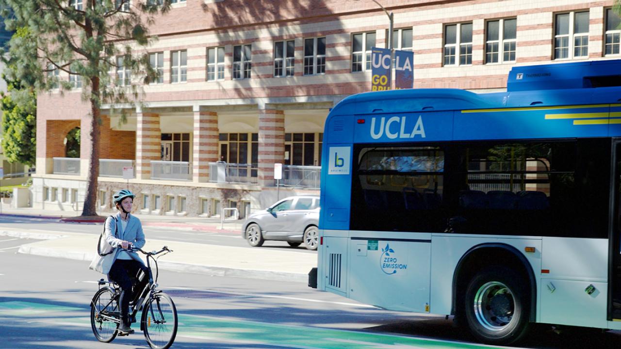 Electric bus and bicyclist on campus