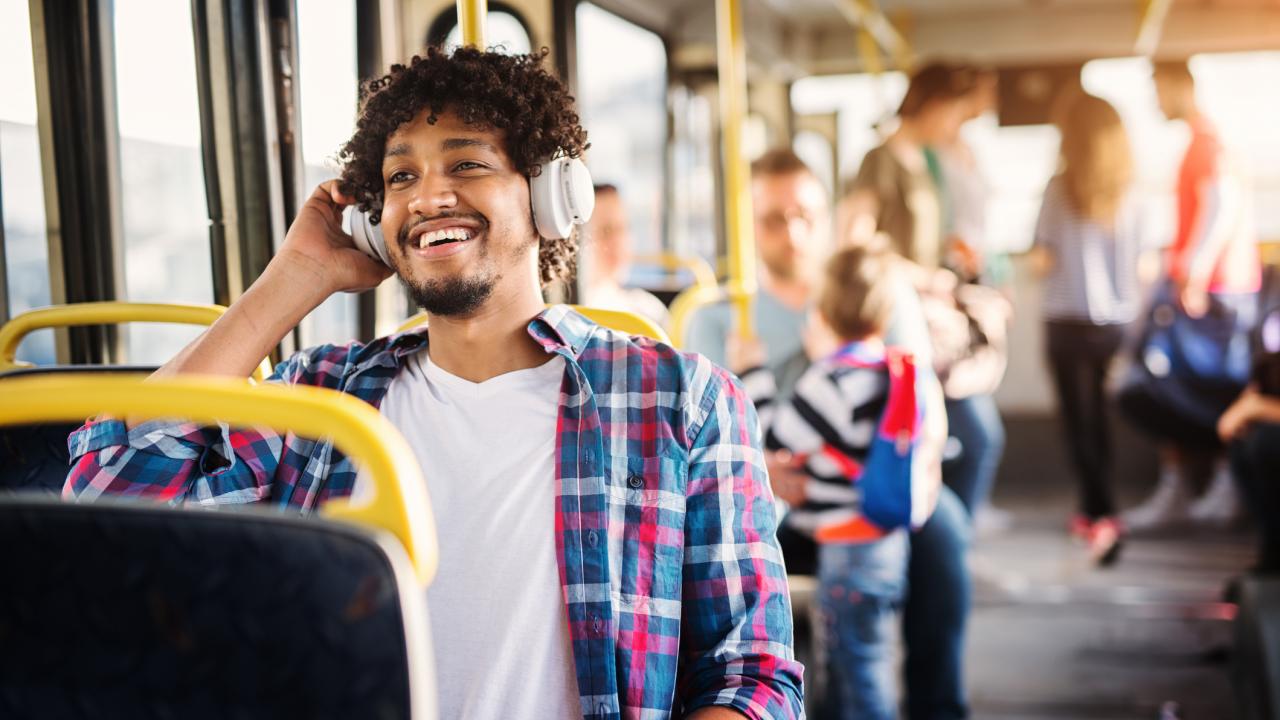 Man with headphones riding the bus