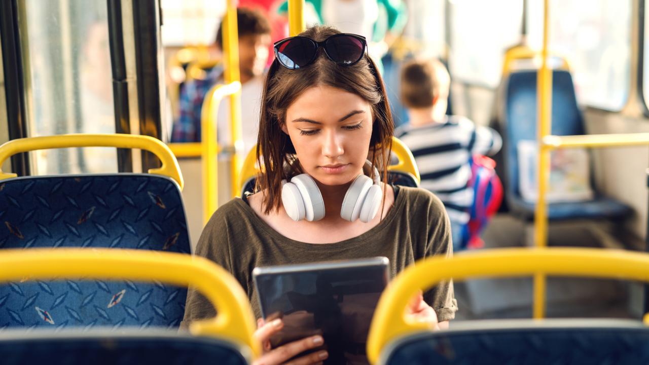 Woman on Bus with Tablet