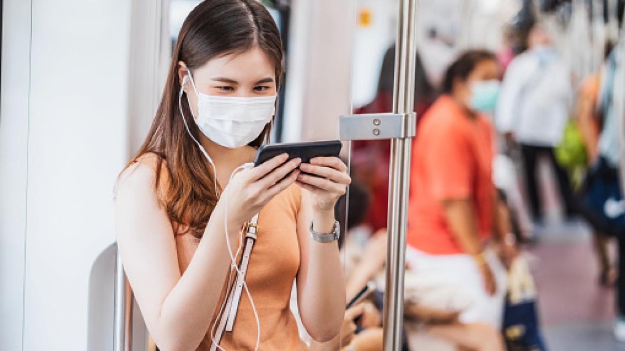 Woman riding transit listening to music