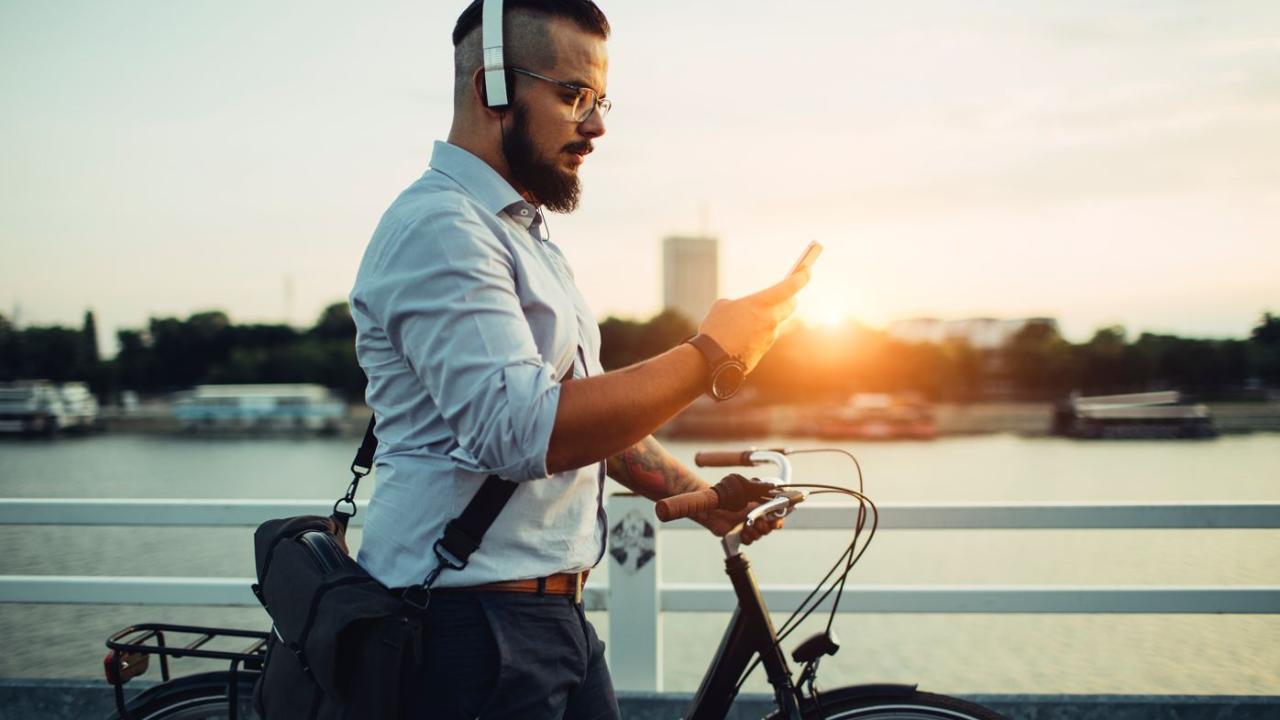 Commuter Listening to Music and Walking Bike