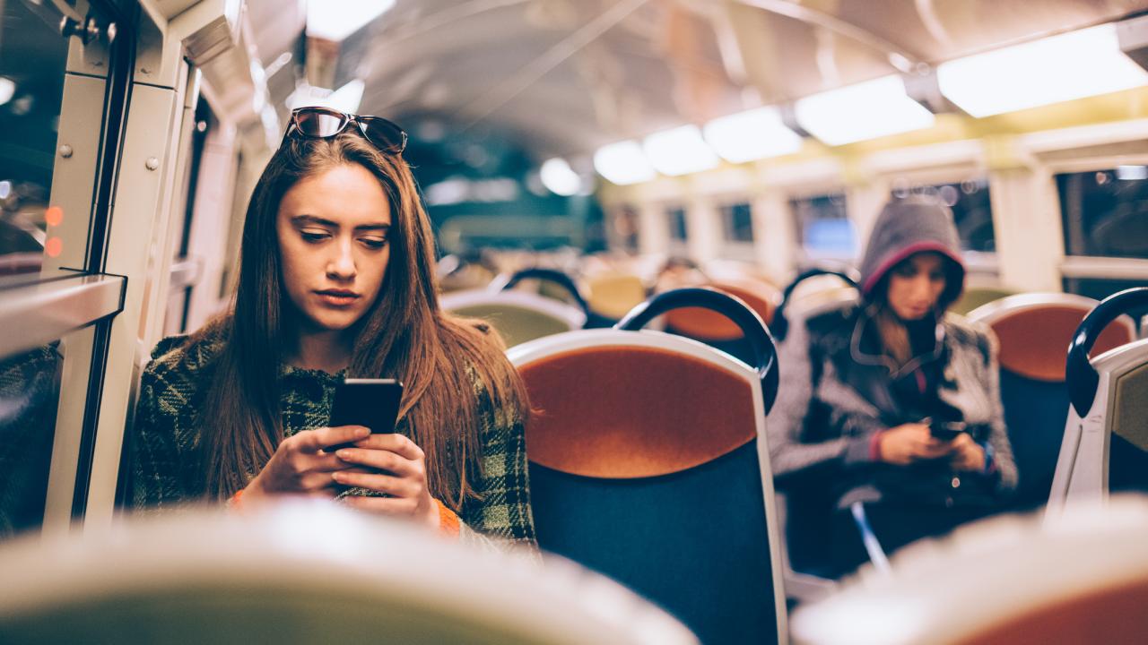 Woman riding bus at night