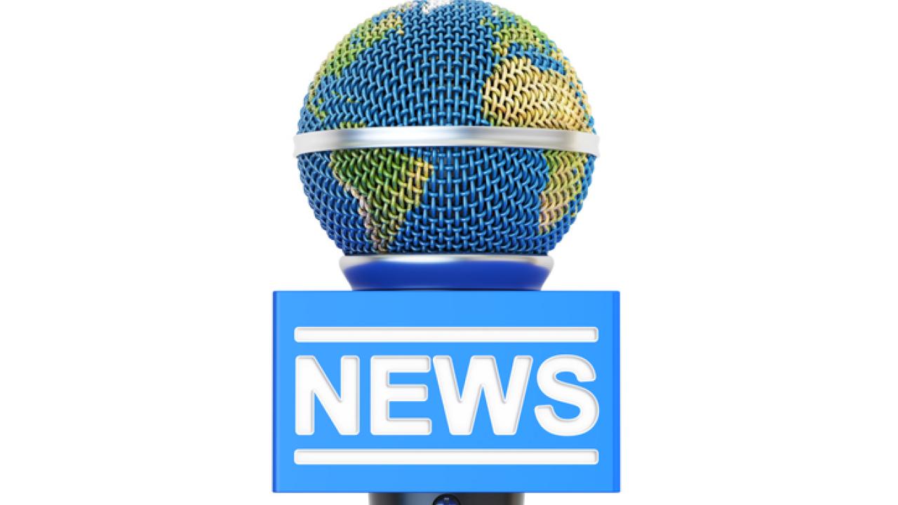 Microphone in the shape of Earth delivering the news