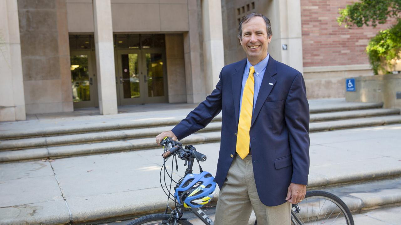Michael Beck in front of Murphy Hall with a bike