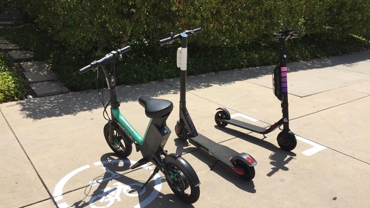 E-scooters and e-bikes parked at a designated spot on campus