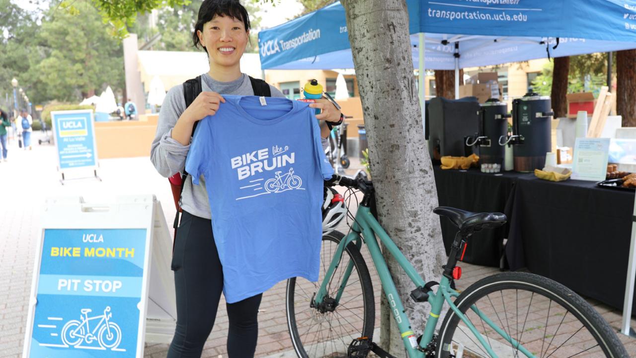 Smiling Bruin cyclist on campus at UCLA.