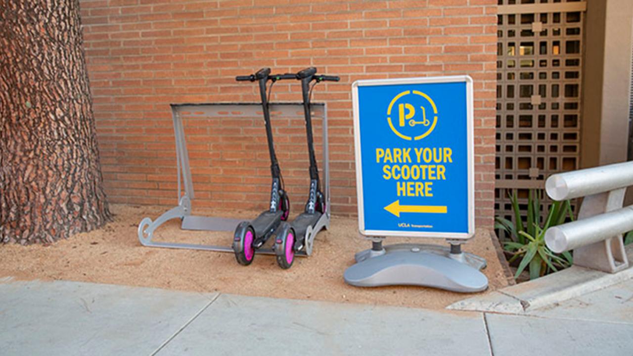 Electric scooters parked at a scooter rack