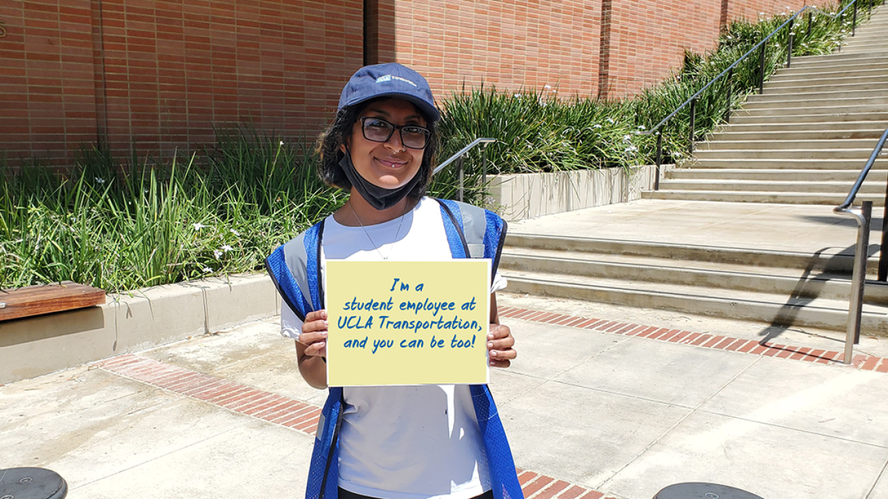 Student employee with sign