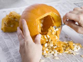 Carved pumpkin on newspaper