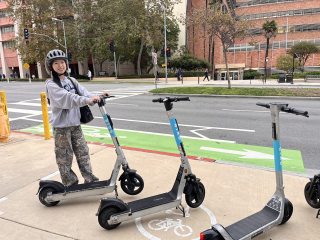 Student Liana parking her scooter in the designated area on campus.