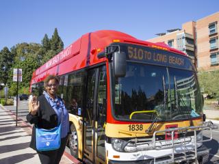 Althea Nelson next to a Long Beach Transit bus