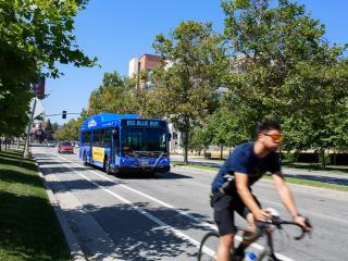 Bus and cyclist on campus