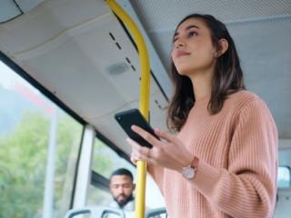 Woman looking at her smartphone on the bus