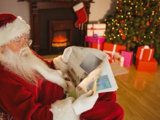 Santa reading a newspaper