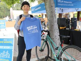 Smiling Bruin cyclist on campus at UCLA.
