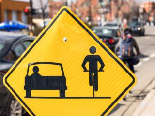 Sign urging drivers and cyclists to share the road