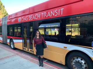 Long Beach Transit passenger in front of bus